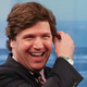 Tucker Carlson, seen checking to remind himself he's not made purely of sap. (Photo by: Rob Kim/Getty)